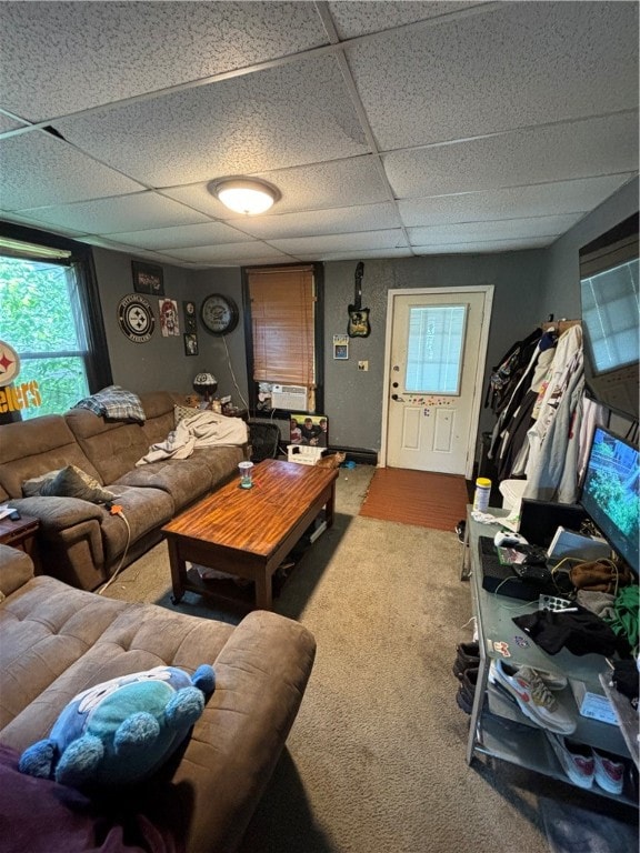 living room with carpet flooring and a paneled ceiling