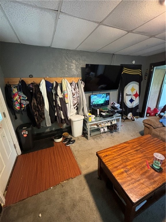 living room with carpet floors and a drop ceiling