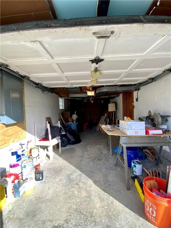 garage with concrete block wall and electric panel