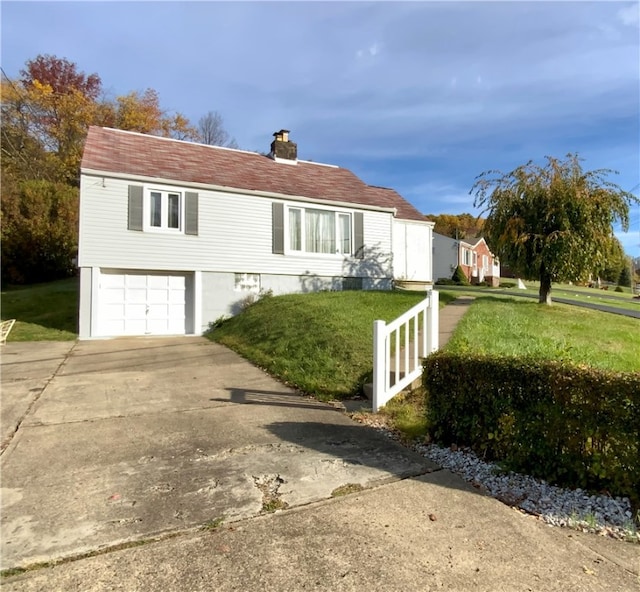 view of front of property featuring a garage and a front lawn