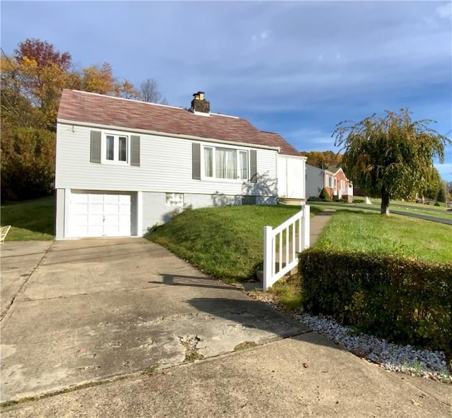 view of front of house with concrete driveway, an attached garage, a chimney, and a front lawn