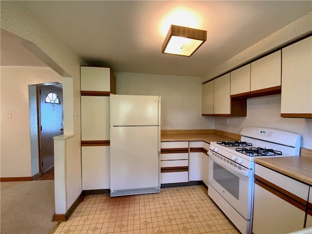 kitchen featuring white appliances and light tile flooring