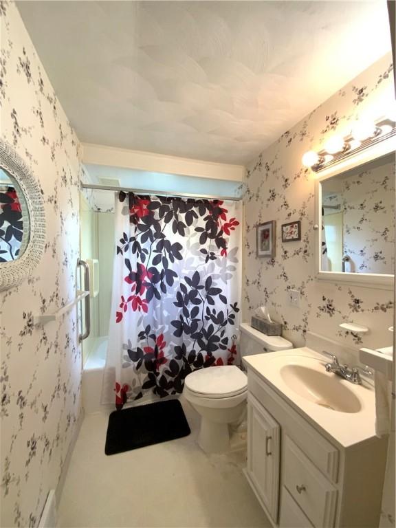 full bathroom featuring toilet, shower / bath combination, vanity, and wallpapered walls