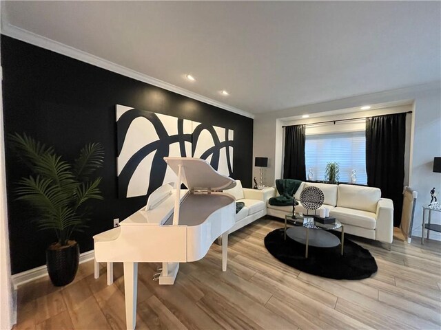 living room featuring ornamental molding and light wood-type flooring