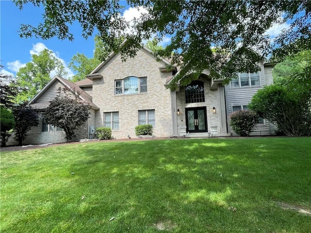 view of front of home featuring a front yard and french doors