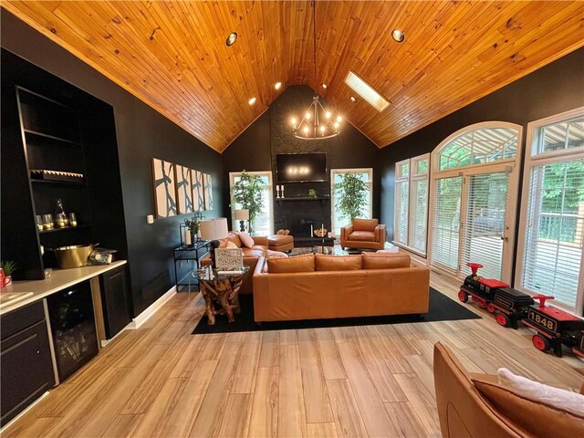 living room featuring a wealth of natural light, wooden ceiling, and light hardwood / wood-style floors