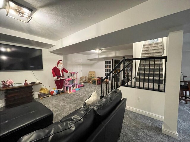 living room with a textured ceiling and dark carpet