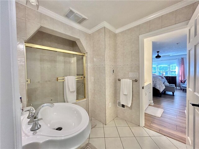 bathroom with tile walls and hardwood / wood-style flooring