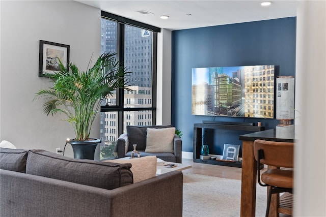 living room featuring hardwood / wood-style flooring and a wall of windows