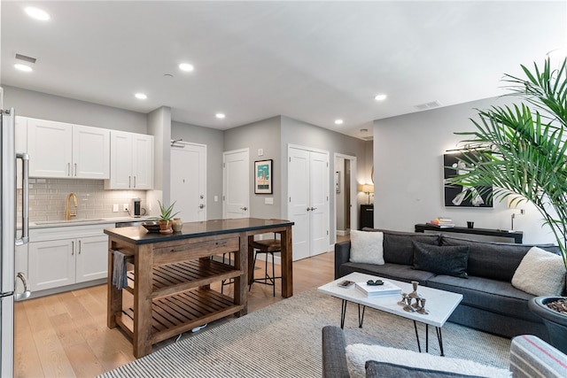 interior space featuring sink and light hardwood / wood-style flooring