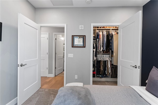 bedroom with a spacious closet, a closet, and carpet floors