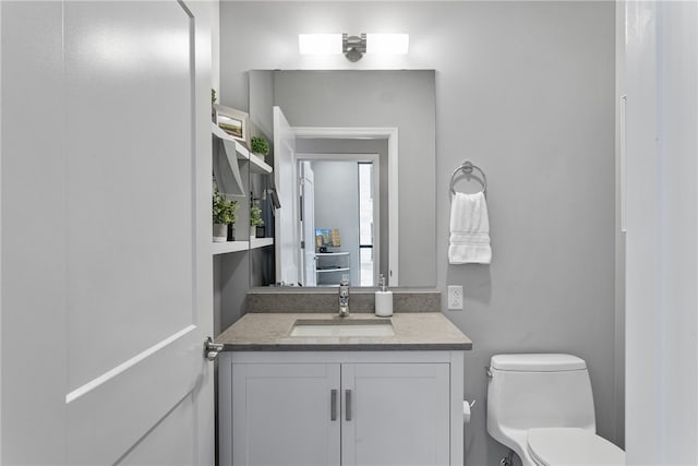 bathroom featuring oversized vanity and toilet