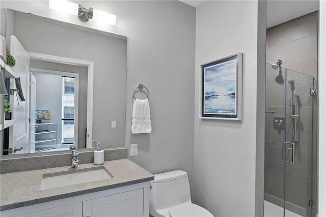 bathroom featuring walk in shower, vanity, and toilet