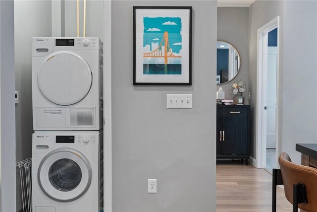 350 Oliver Ave Unit 908, Downtown Pgh, PA 15222 - clothes washing area featuring laundry area, light wood-type flooring, baseboards, and stacked washer and dryer