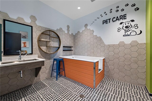 350 Oliver Ave Unit 908, Downtown Pgh, PA 15222 - bathroom with tile patterned floors, tile walls, recessed lighting, and a garden tub