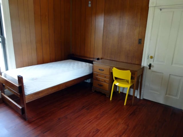 bedroom with dark hardwood / wood-style floors