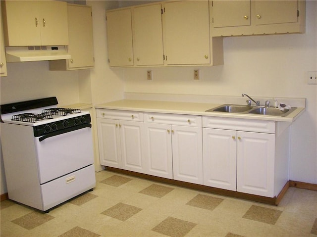 kitchen with white range with gas cooktop, sink, and white cabinetry