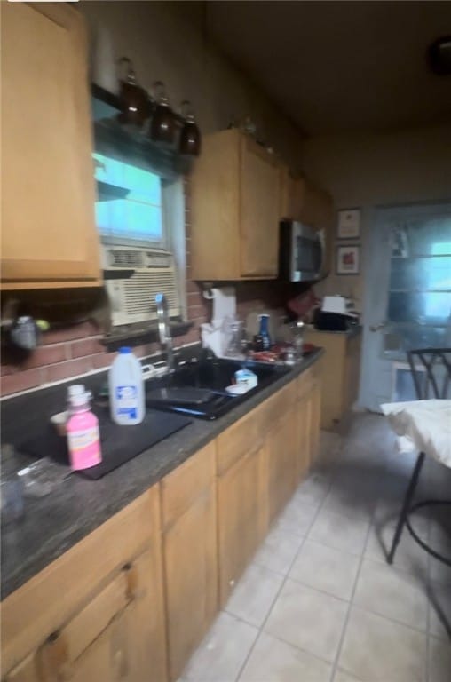 kitchen featuring light brown cabinets and light tile patterned floors