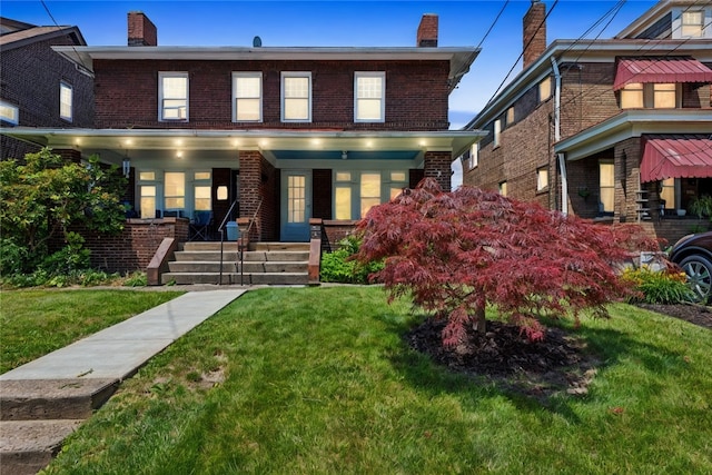 view of front facade with a front yard and a porch