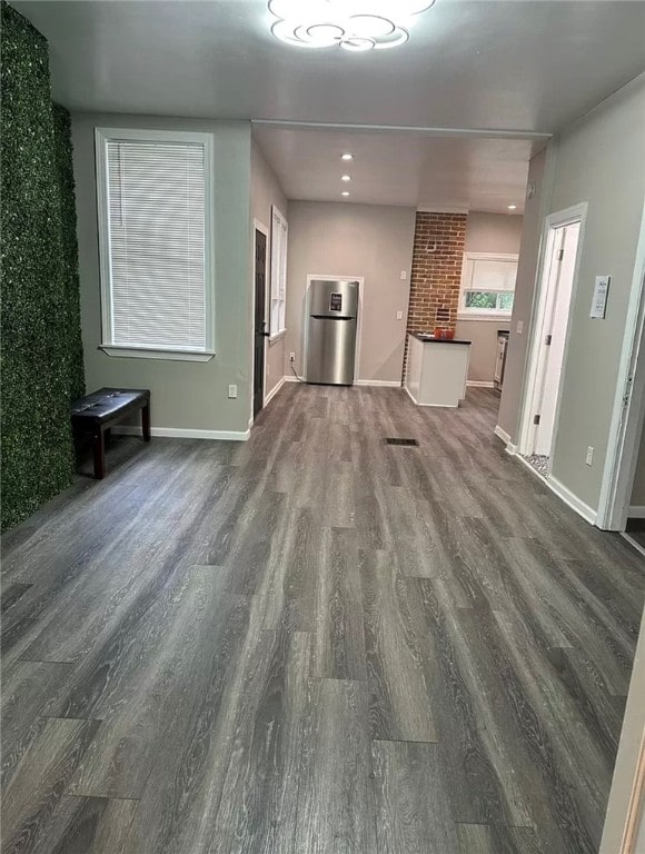 unfurnished living room with dark hardwood / wood-style floors