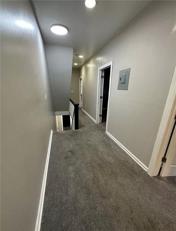 hall featuring dark colored carpet