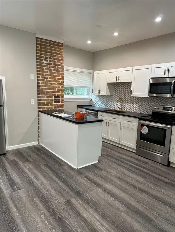 kitchen featuring white cabinetry, dark hardwood / wood-style floors, tasteful backsplash, and stainless steel appliances