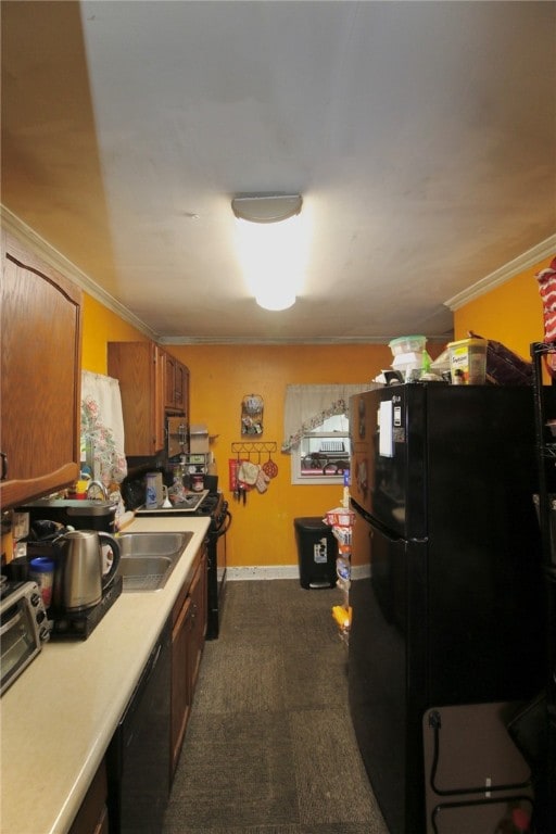 kitchen featuring dark carpet, sink, ornamental molding, and black appliances