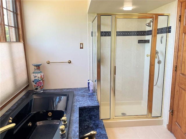 bathroom with separate shower and tub and tile patterned floors