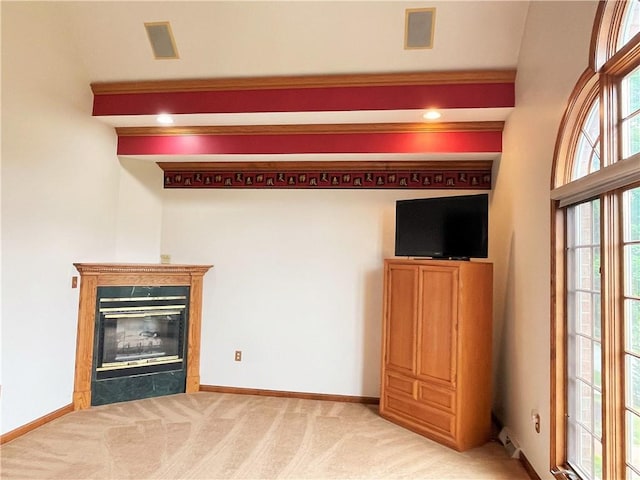 unfurnished living room featuring light carpet