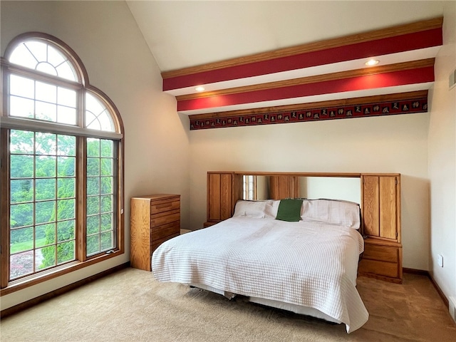 bedroom featuring carpet flooring, lofted ceiling, and multiple windows