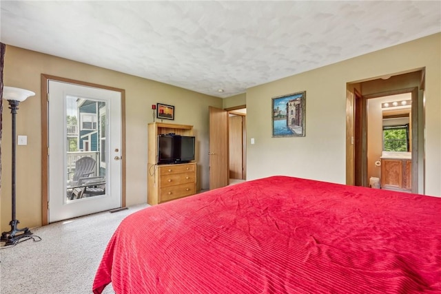 carpeted bedroom featuring access to exterior