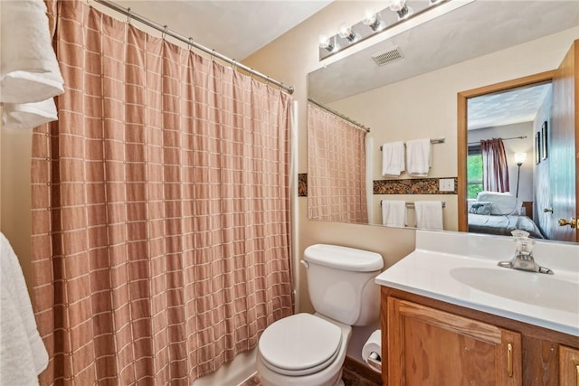 bathroom with toilet, vanity, and a shower with curtain