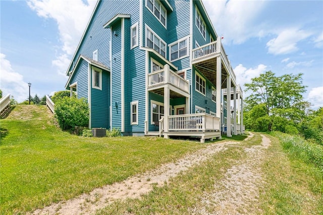 rear view of property featuring a lawn