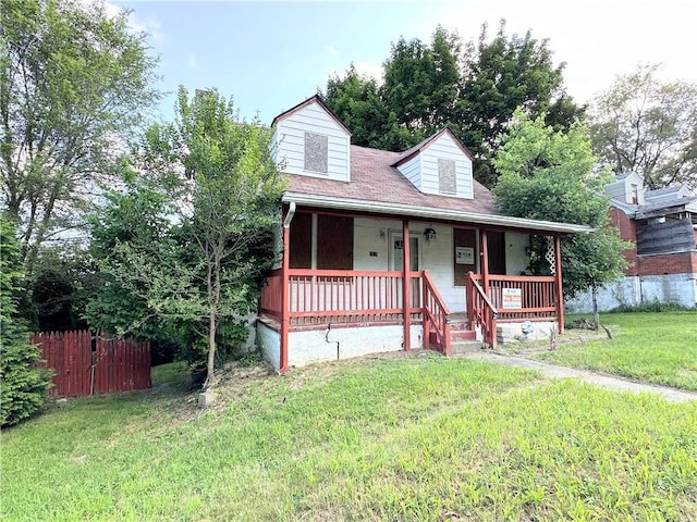 view of front of house with covered porch and a front yard