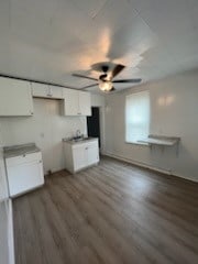 kitchen featuring white cabinets, dark wood-type flooring, and ceiling fan