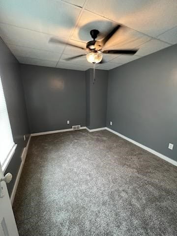 spare room with carpet, ceiling fan, and a drop ceiling