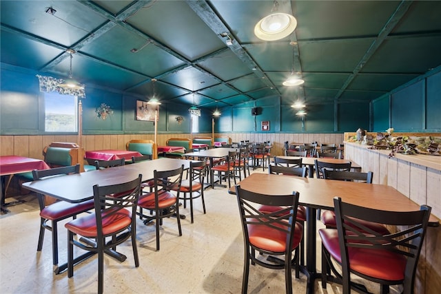 dining space with coffered ceiling, light tile floors, and lofted ceiling