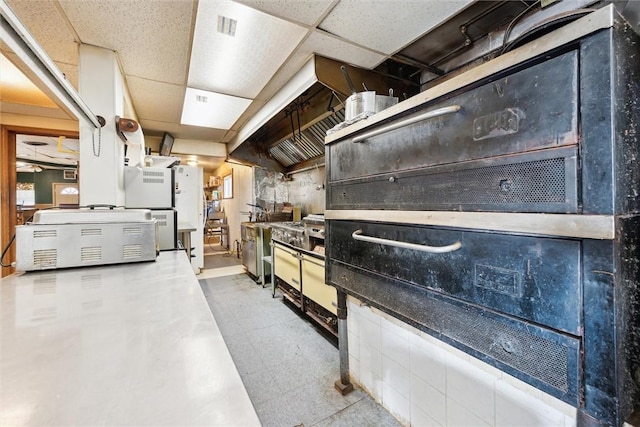 kitchen featuring a drop ceiling