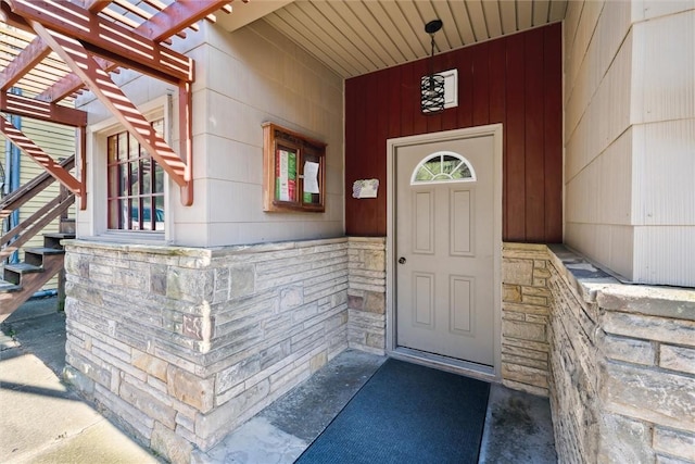 entrance to property featuring a pergola