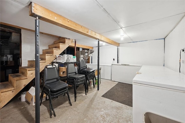 basement with washer and clothes dryer and fridge