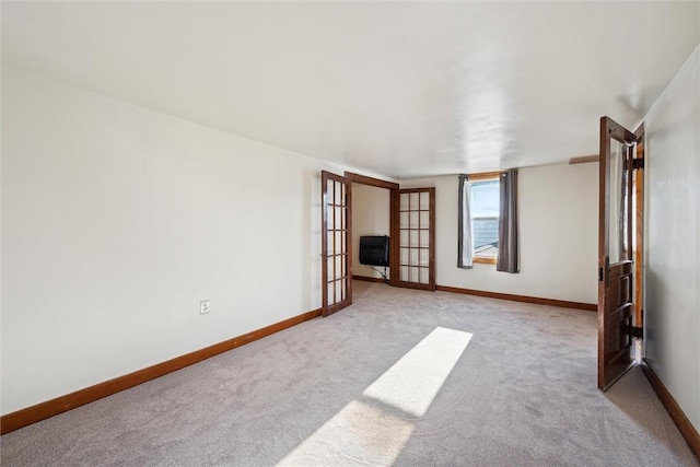 carpeted empty room with french doors