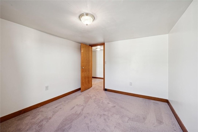 empty room featuring light carpet