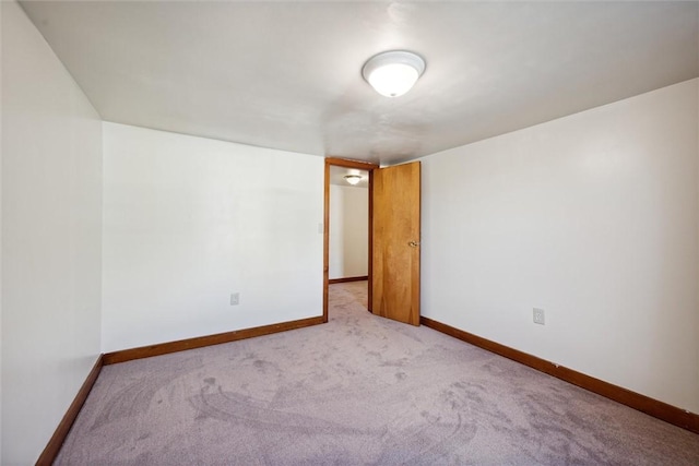 spare room featuring light colored carpet