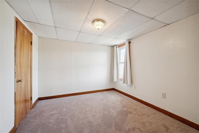 unfurnished room featuring a drop ceiling and carpet flooring