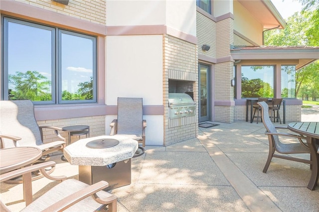 view of patio / terrace featuring area for grilling, a grill, and a fire pit