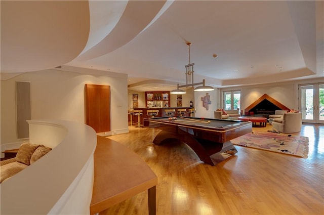 rec room featuring a wealth of natural light, pool table, and light hardwood / wood-style flooring