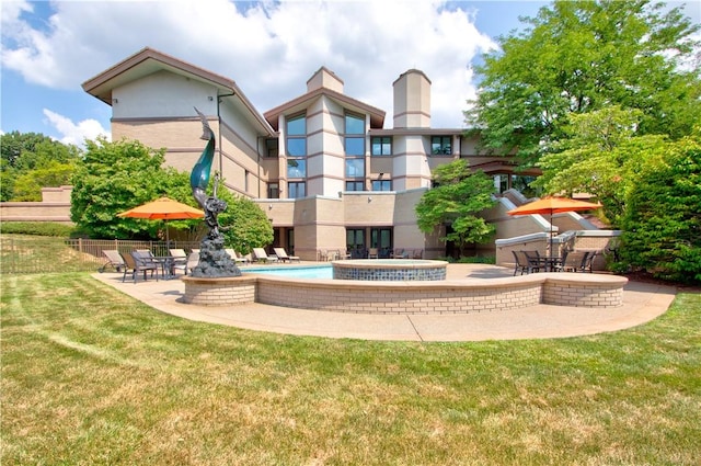 exterior space with a fenced in pool, a lawn, and a patio