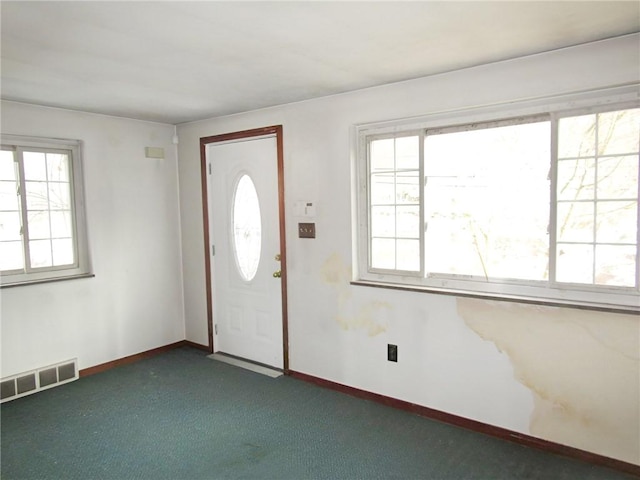 entryway featuring dark colored carpet