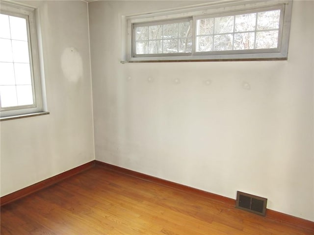 empty room with hardwood / wood-style floors