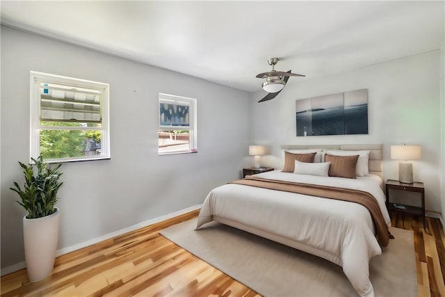 bedroom with wood-type flooring and ceiling fan